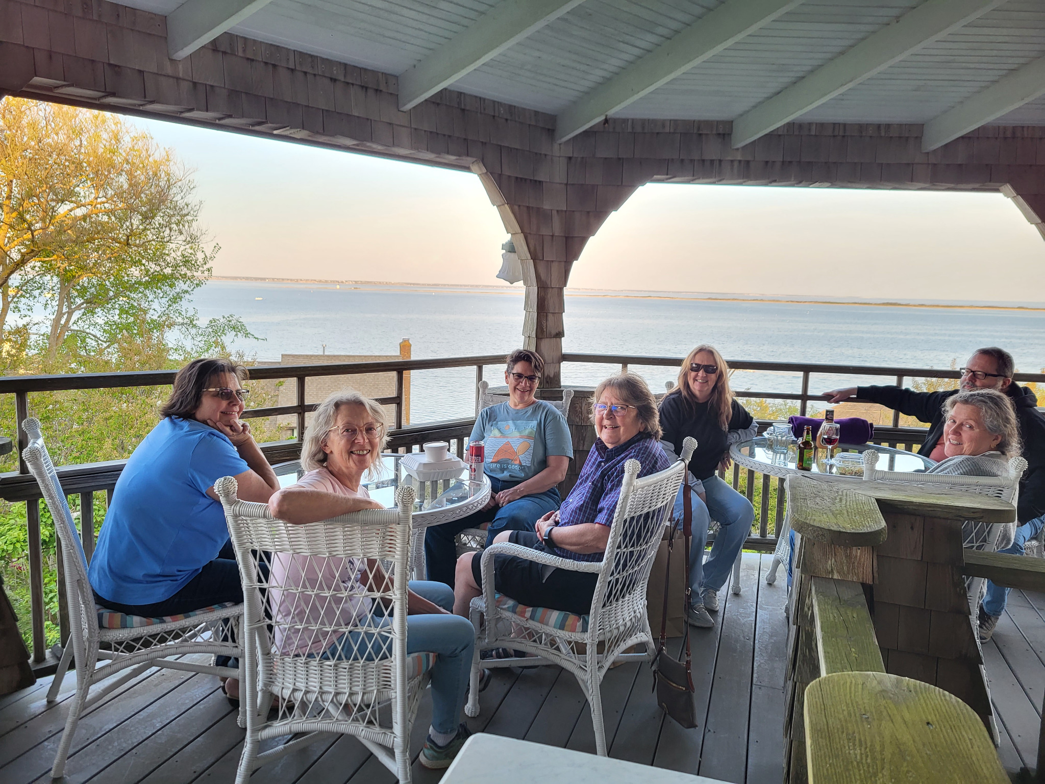Friends enjoying time together on a waterfront porch